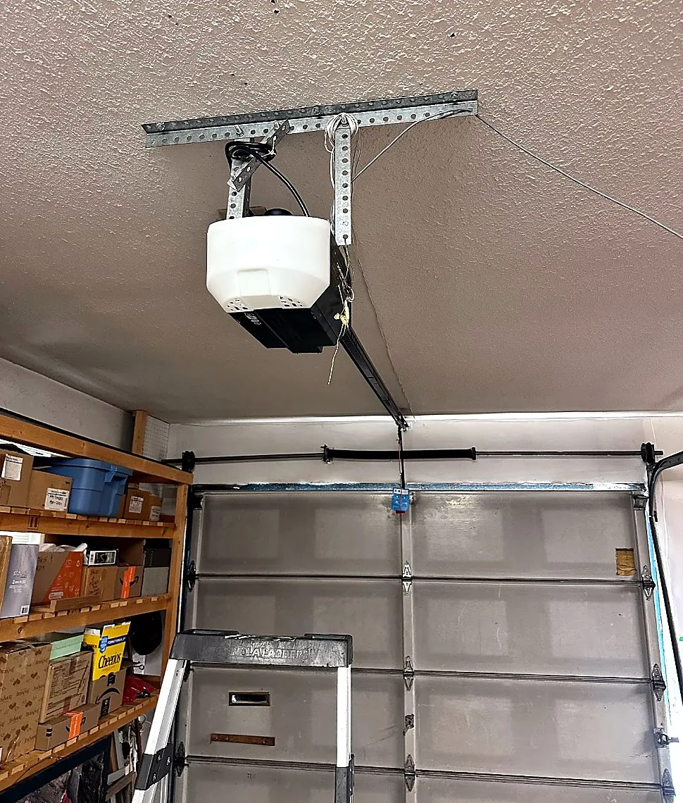 New garage door opener installed on a ceiling rail