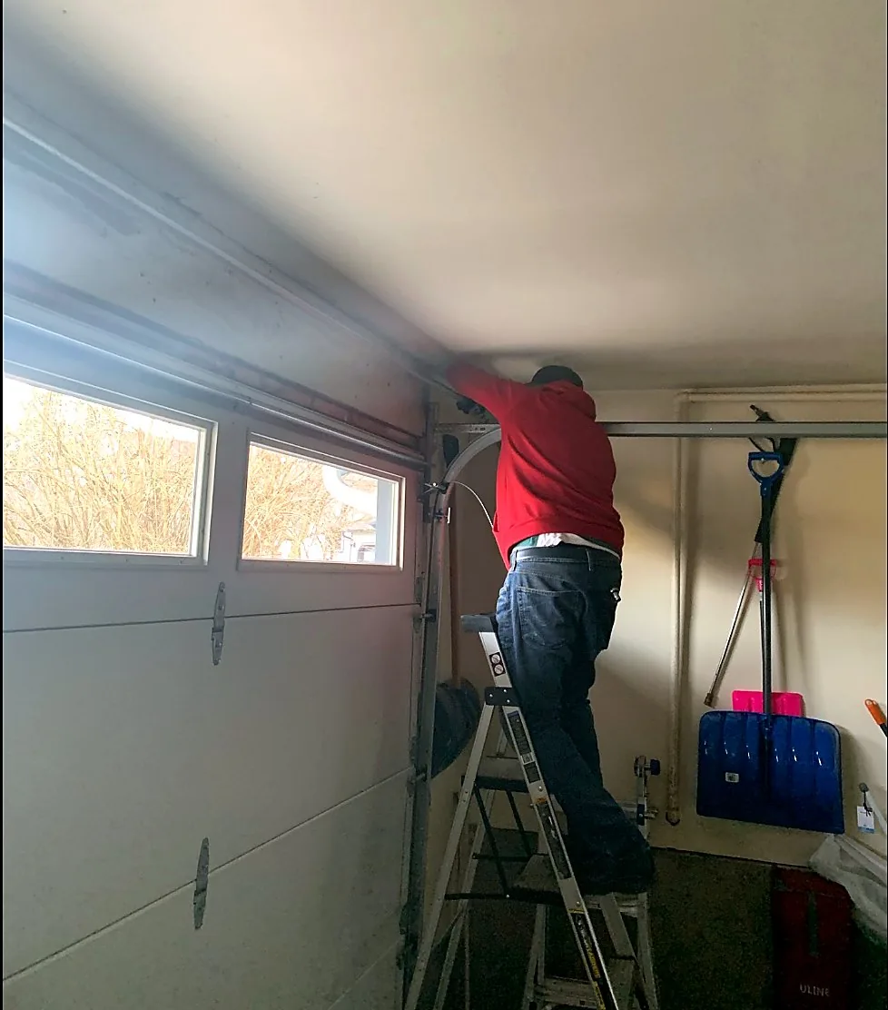 316 technician repairing a residential garage door in Langley BC
